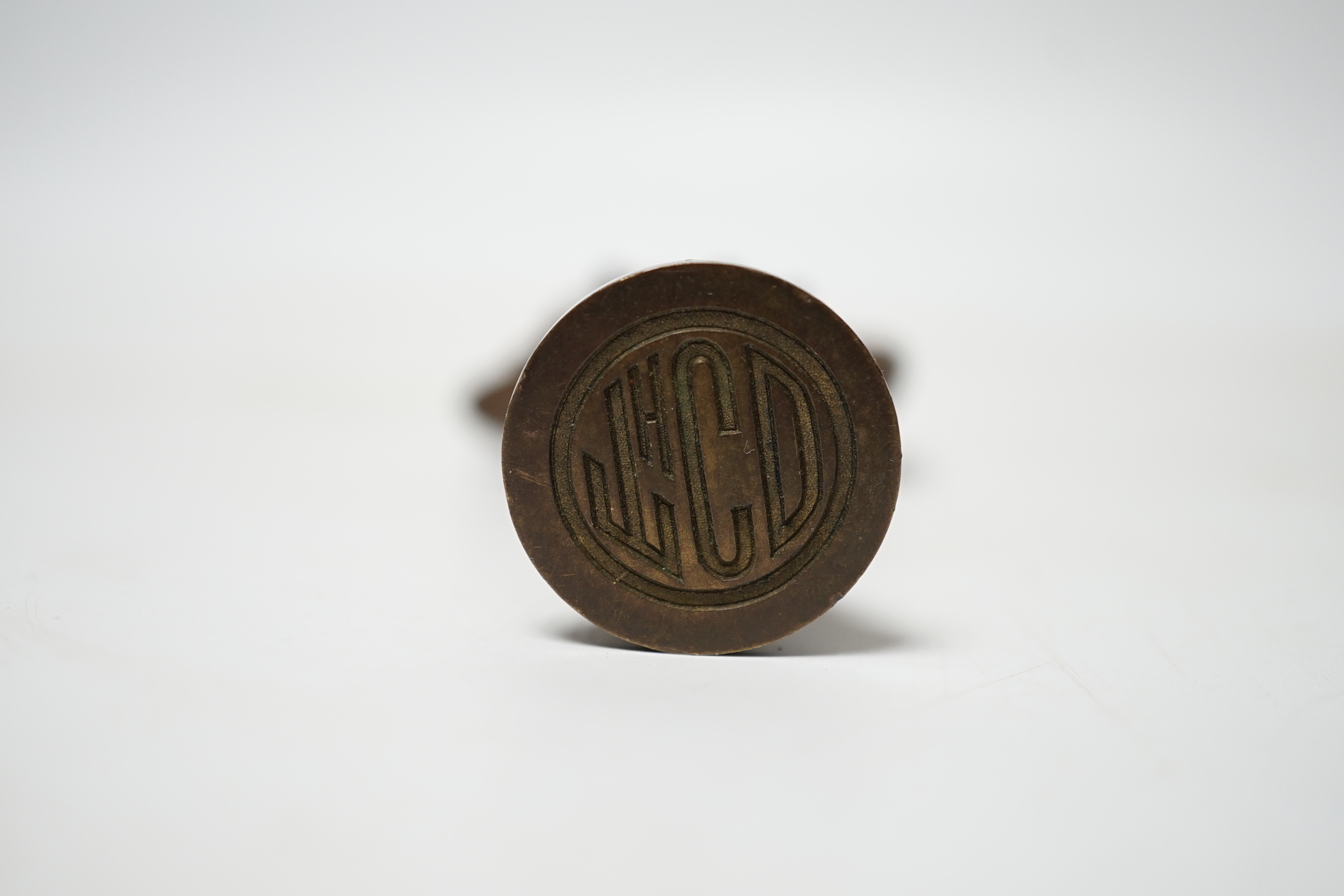 A small Art Nouveau figural bronze desk seal, 8.5cm high